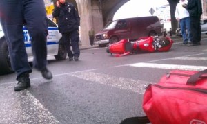 Photo of crashed motorcycle on the street after being cut off by a car
