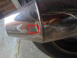 Photo showing car paint on a motorcycle exhaust