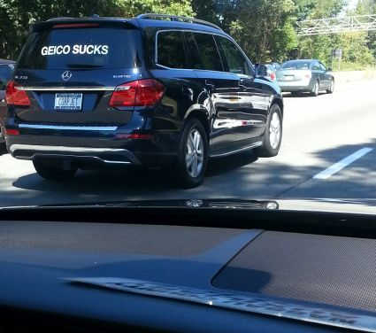 GEICO SUCKS sign on a car